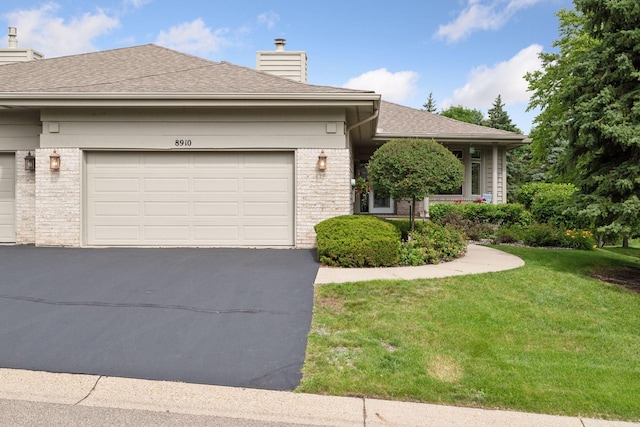 8910 Hilloway Rd, Eden Prairie, MN 55347 - ranch-style house featuring a chimney, driveway, a front lawn, and a shingled roof