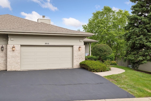 8910 Hilloway Rd, Eden Prairie, MN 55347 - view of side of home featuring brick siding, driveway, a chimney, and a shingled roof