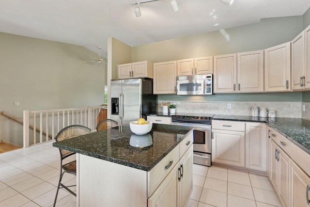 8910 Hilloway Rd, Eden Prairie, MN 55347 - kitchen featuring appliances with stainless steel finishes, light tile patterned floors, a breakfast bar area, a ceiling fan, and lofted ceiling