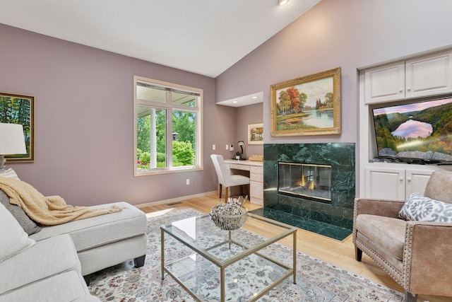 8910 Hilloway Rd, Eden Prairie, MN 55347 - living room featuring lofted ceiling, light wood-style flooring, a premium fireplace, and recessed lighting