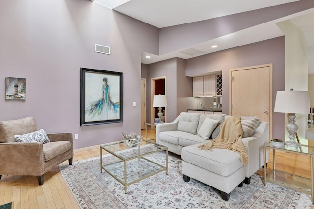 8910 Hilloway Rd, Eden Prairie, MN 55347 - living room featuring recessed lighting, light wood-style flooring, and bar area