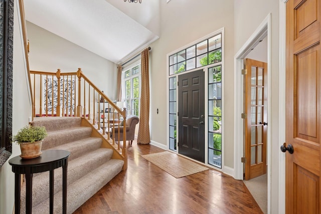 6253 Niagara Ct N, Maple Grove, MN 55311 - foyer with high vaulted ceiling, wood finished floors, stairs, and baseboards