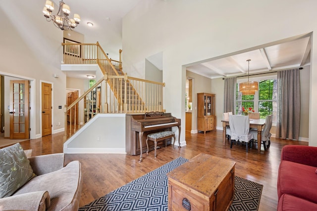 6253 Niagara Ct N, Maple Grove, MN 55311 - living room with a chandelier, stairs, wood finished floors, baseboards, and a towering ceiling