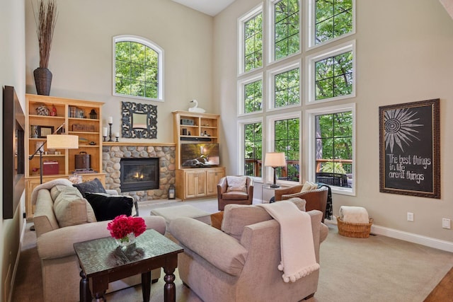 6253 Niagara Ct N, Maple Grove, MN 55311 - living area with a towering ceiling, baseboards, a stone fireplace, and carpet