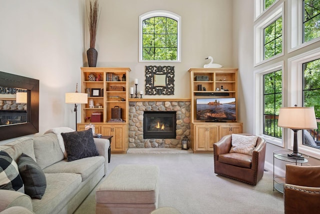 6253 Niagara Ct N, Maple Grove, MN 55311 - carpeted living area featuring a fireplace, a towering ceiling, and plenty of natural light