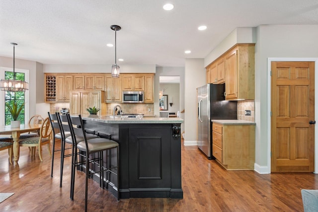 6253 Niagara Ct N, Maple Grove, MN 55311 - kitchen with stainless steel appliances, a kitchen bar, tasteful backsplash, recessed lighting, and dark wood-style flooring