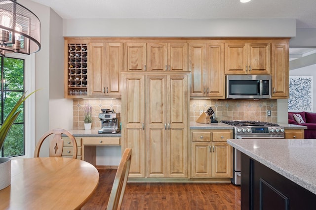 6253 Niagara Ct N, Maple Grove, MN 55311 - kitchen featuring appliances with stainless steel finishes, dark wood finished floors, light stone counters, and backsplash
