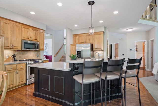 6253 Niagara Ct N, Maple Grove, MN 55311 - kitchen with appliances with stainless steel finishes, dark wood-style floors, tasteful backsplash, an island with sink, and recessed lighting