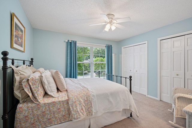 6253 Niagara Ct N, Maple Grove, MN 55311 - bedroom with two closets, light carpet, a textured ceiling, a ceiling fan, and baseboards