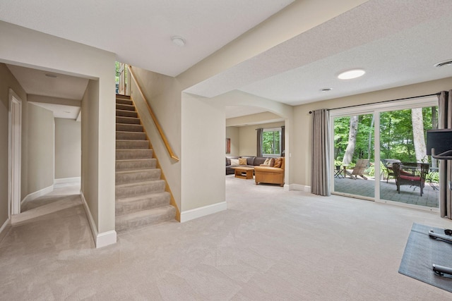 6253 Niagara Ct N, Maple Grove, MN 55311 - living area with carpet flooring, stairway, baseboards, and arched walkways