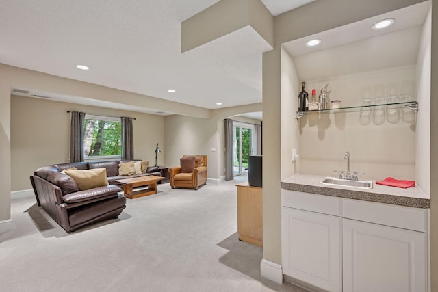 6253 Niagara Ct N, Maple Grove, MN 55311 - living area featuring bar with sink, light colored carpet, recessed lighting, and baseboards