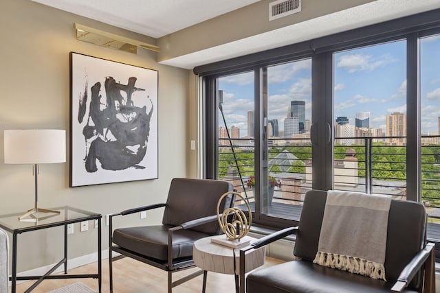 52 Groveland Ter Unit A402, Minneapolis, MN 55403 - sitting room with wood finished floors, a view of skyline, and baseboards