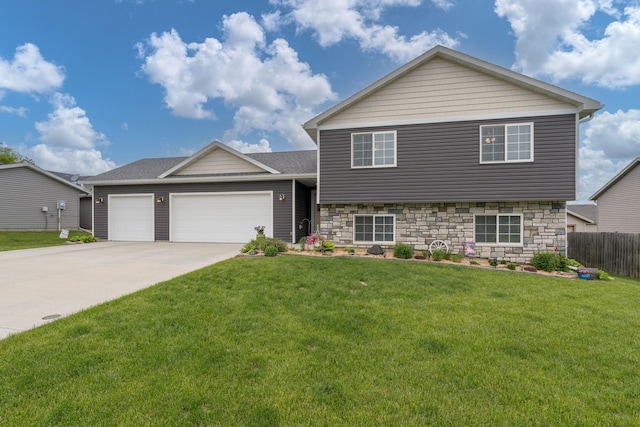 641 Beverly St, Wanamingo, MN 55983 - split level home with a garage, driveway, stone siding, and roof with shingles