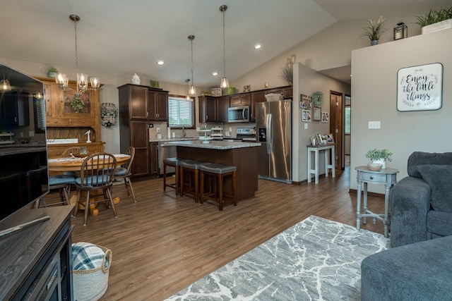 641 Beverly St, Wanamingo, MN 55983 - living area featuring wood finished floors, vaulted ceiling, a chandelier, and recessed lighting