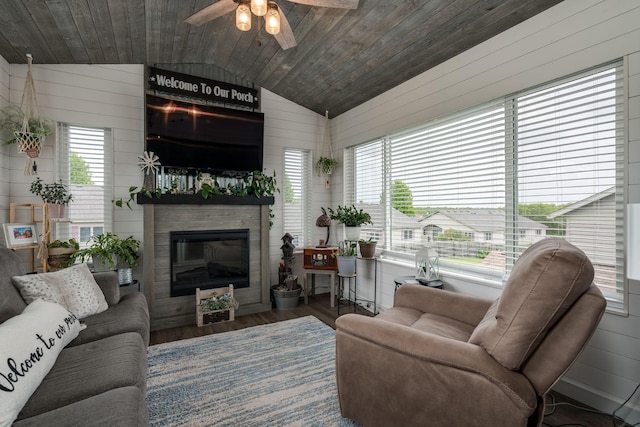 641 Beverly St, Wanamingo, MN 55983 - living room featuring vaulted ceiling, wooden ceiling, ceiling fan, plenty of natural light, and a glass covered fireplace