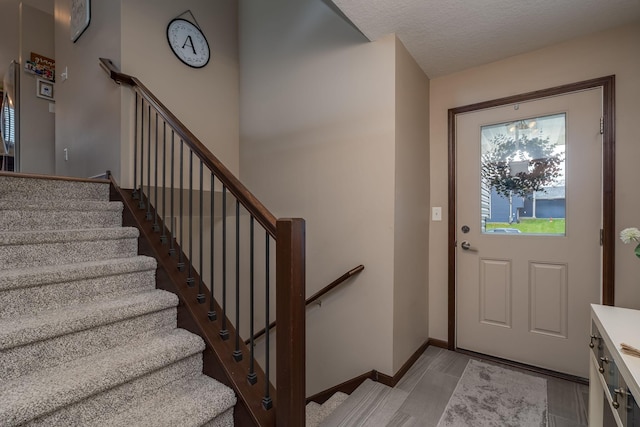 641 Beverly St, Wanamingo, MN 55983 - entrance foyer featuring stairway and a textured ceiling