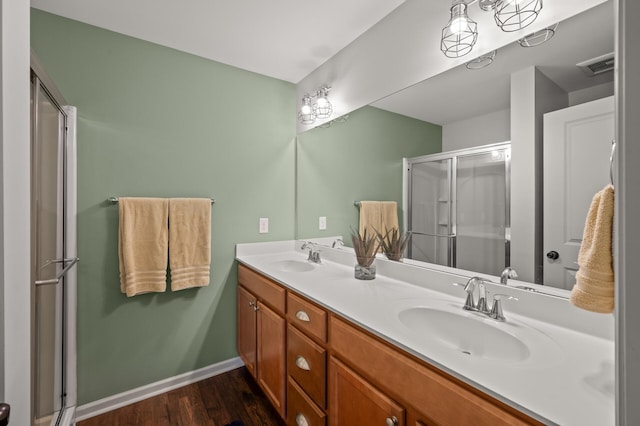 3474 White Pine Way, Stillwater, MN 55082 - bathroom with double vanity, a stall shower, wood finished floors, and baseboards