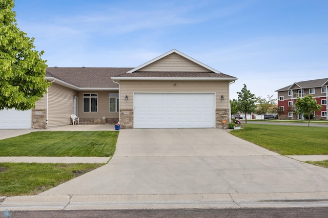 4388 52nd St S, Fargo, ND 58104 - view of front facade featuring a front yard, a garage, driveway, and roof with shingles