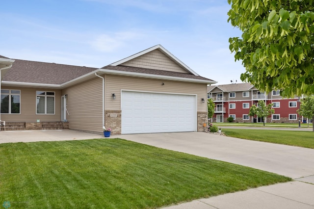4388 52nd St S, Fargo, ND 58104 - view of front of house with a front lawn, driveway, an attached garage, and a shingled roof