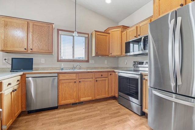 4388 52nd St S, Fargo, ND 58104 - kitchen with stainless steel appliances, light countertops, light wood-style flooring, hanging light fixtures, and recessed lighting
