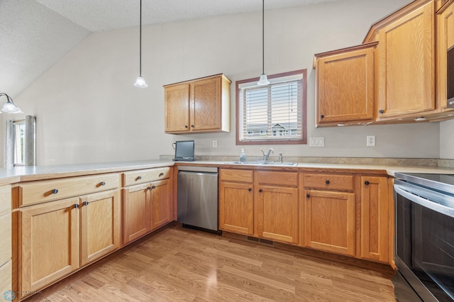 4388 52nd St S, Fargo, ND 58104 - kitchen featuring stainless steel appliances, vaulted ceiling, light wood-style flooring, light countertops, and a peninsula