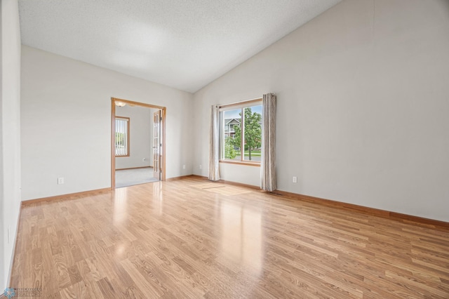 4388 52nd St S, Fargo, ND 58104 - empty room with light wood finished floors and high vaulted ceiling