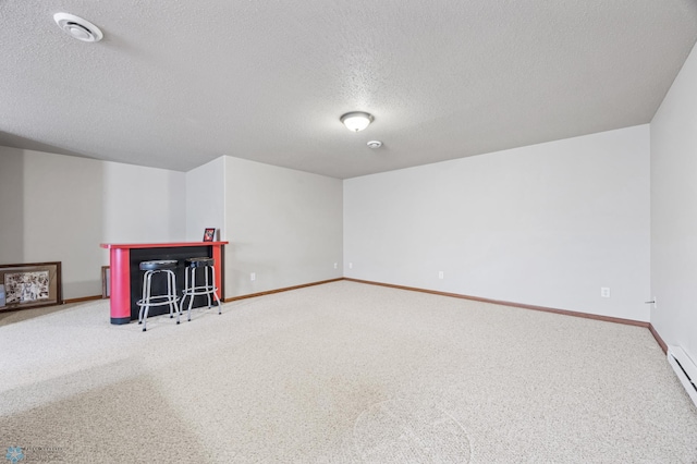 4388 52nd St S, Fargo, ND 58104 - bonus room with a textured ceiling, carpet flooring, and a baseboard heating unit