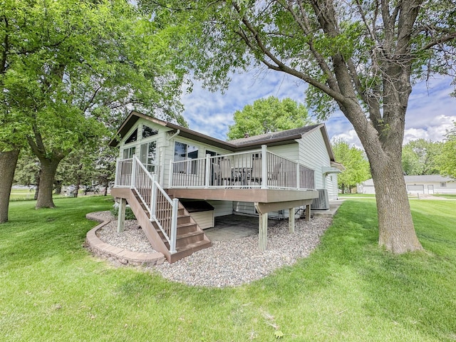 731 Grove Ave, Bird Island, MN 55310 - rear view of house with stairs, a deck, a lawn, and central AC unit