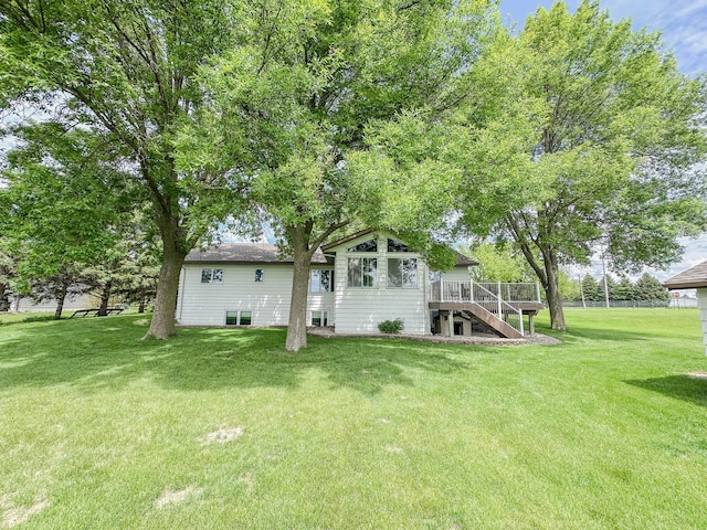 731 Grove Ave, Bird Island, MN 55310 - back of property with stairs, a deck, and a yard