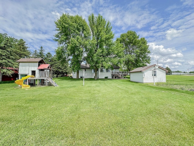 731 Grove Ave, Bird Island, MN 55310 - view of grassy yard featuring a playground and an outbuilding