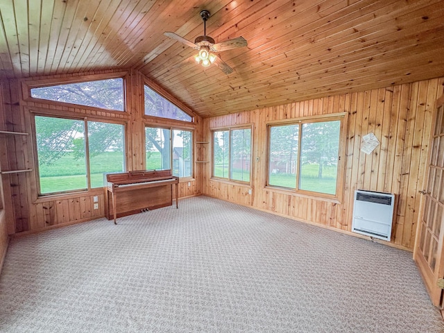 731 Grove Ave, Bird Island, MN 55310 - unfurnished sunroom featuring heating unit, healthy amount of natural light, vaulted ceiling, wooden walls, and carpet floors
