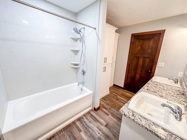 731 Grove Ave, Bird Island, MN 55310 - full bath with wood finished floors, shower / bathtub combination, double vanity, and baseboards