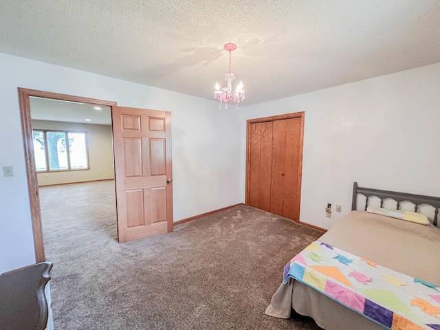 731 Grove Ave, Bird Island, MN 55310 - bedroom with carpet flooring, a chandelier, a textured ceiling, baseboards, and a closet