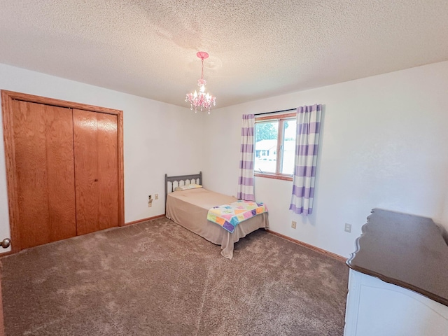 731 Grove Ave, Bird Island, MN 55310 - carpeted bedroom with a textured ceiling, a closet, a chandelier, and baseboards