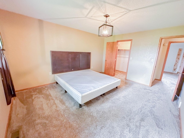 731 Grove Ave, Bird Island, MN 55310 - bedroom with carpet floors, baseboards, and a spacious closet