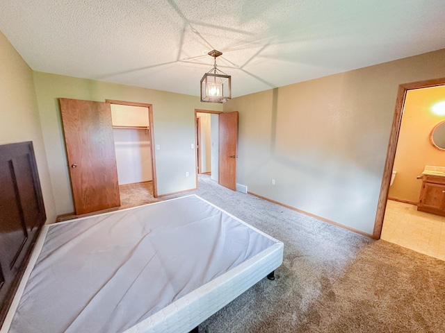 731 Grove Ave, Bird Island, MN 55310 - unfurnished bedroom with carpet, ensuite bathroom, baseboards, and a walk in closet