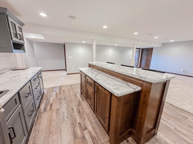731 Grove Ave, Bird Island, MN 55310 - kitchen with a center island, light wood-style flooring, baseboards, and recessed lighting