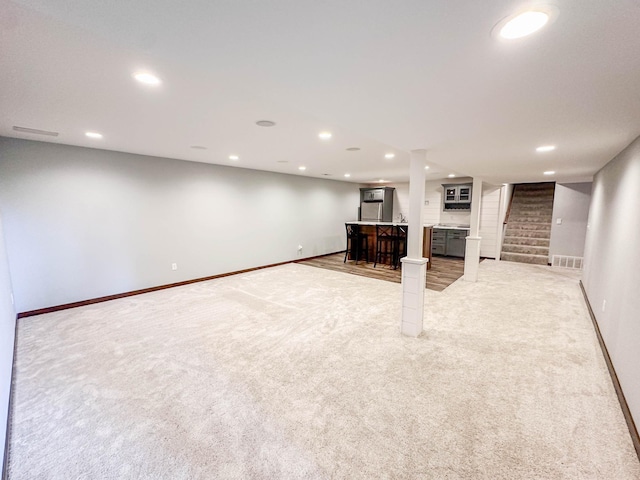 731 Grove Ave, Bird Island, MN 55310 - finished below grade area featuring light carpet, baseboards, recessed lighting, and stairway