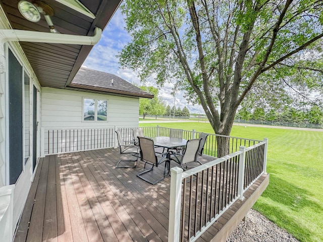 731 Grove Ave, Bird Island, MN 55310 - wooden deck featuring outdoor dining area and a yard