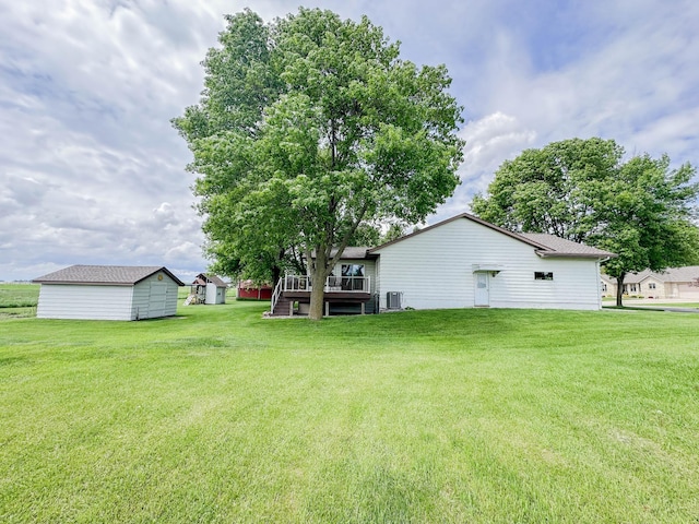 731 Grove Ave, Bird Island, MN 55310 - view of grassy yard with a deck and cooling unit