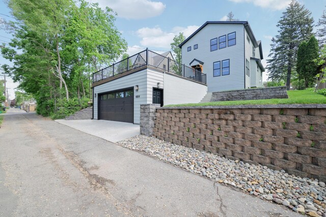 4804 12th Ave S, Minneapolis, MN 55417 - view of property exterior featuring a balcony, concrete driveway, and an attached garage