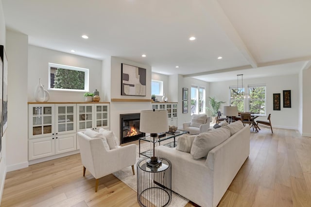 4804 12th Ave S, Minneapolis, MN 55417 - living area featuring a glass covered fireplace, light wood-style flooring, recessed lighting, baseboards, and beamed ceiling
