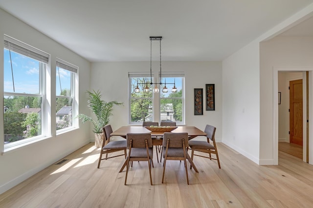 4804 12th Ave S, Minneapolis, MN 55417 - dining area with healthy amount of natural light, light wood finished floors, and a chandelier