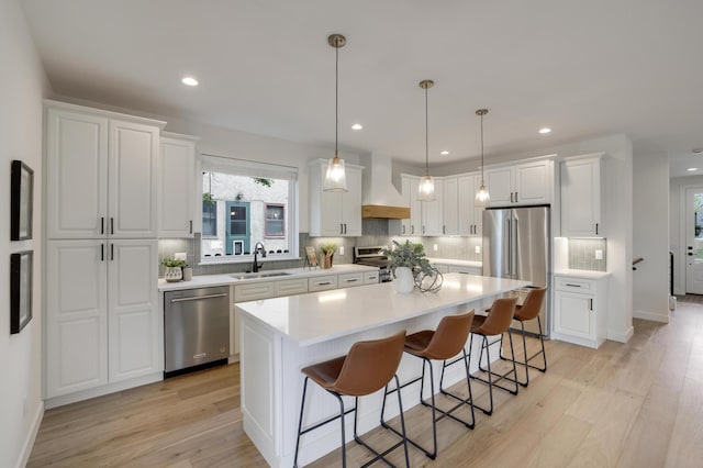 4804 12th Ave S, Minneapolis, MN 55417 - kitchen with high end appliances, custom range hood, a sink, white cabinets, and decorative backsplash