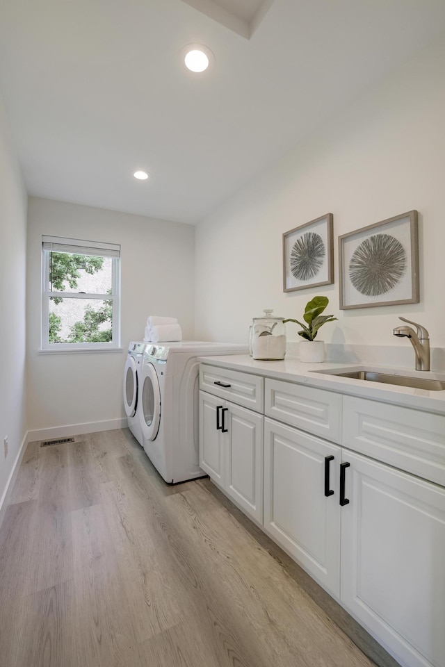 4804 12th Ave S, Minneapolis, MN 55417 - washroom with cabinet space, washing machine and clothes dryer, light wood finished floors, recessed lighting, and baseboards