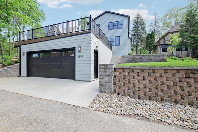 4804 12th Ave S, Minneapolis, MN 55417 - view of home's exterior with a balcony, a garage, and concrete driveway