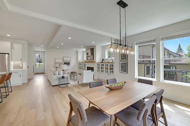 4804 12th Ave S, Minneapolis, MN 55417 - dining space with light wood-style flooring, recessed lighting, a fireplace, and beam ceiling