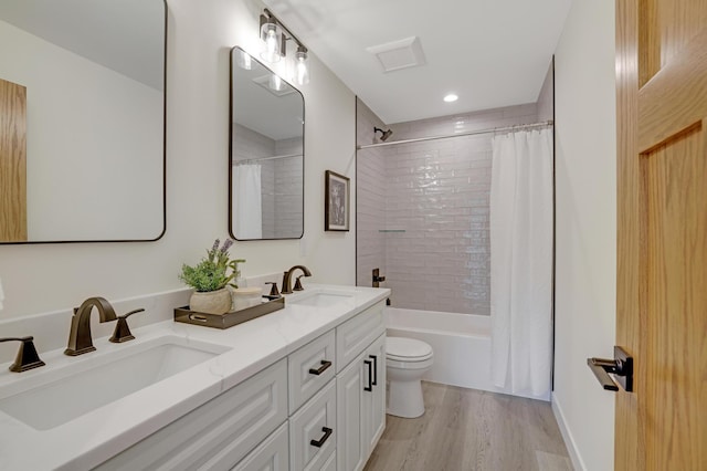 4804 12th Ave S, Minneapolis, MN 55417 - full bathroom featuring double vanity, wood finished floors, toilet, shower / tub combo, and recessed lighting