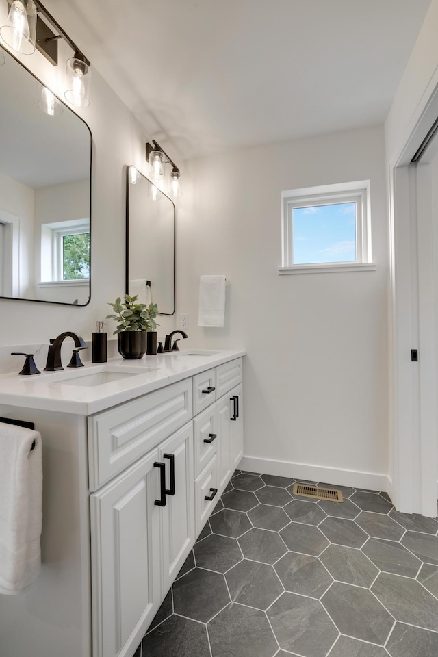 4804 12th Ave S, Minneapolis, MN 55417 - bathroom featuring double vanity and baseboards