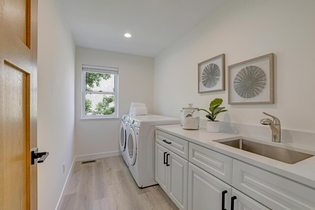 4804 12th Ave S, Minneapolis, MN 55417 - laundry area with cabinet space, washing machine and dryer, light wood-style flooring, baseboards, and recessed lighting